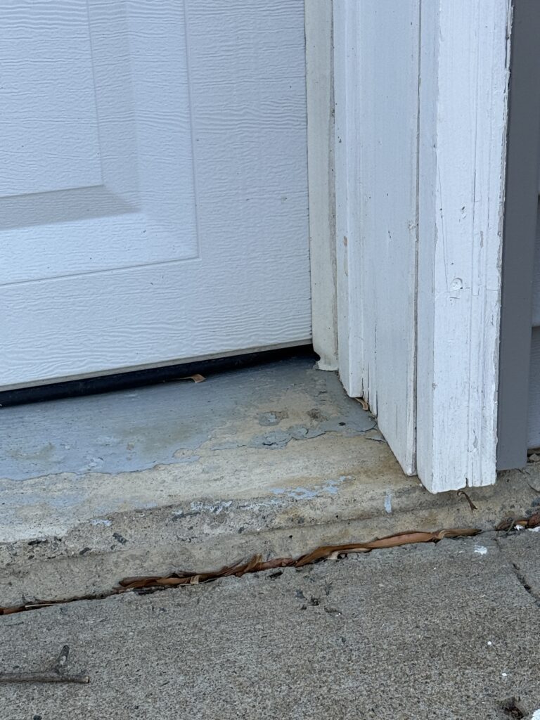 A gap in a garage door in Woodbridge, VA is an entry point for mice